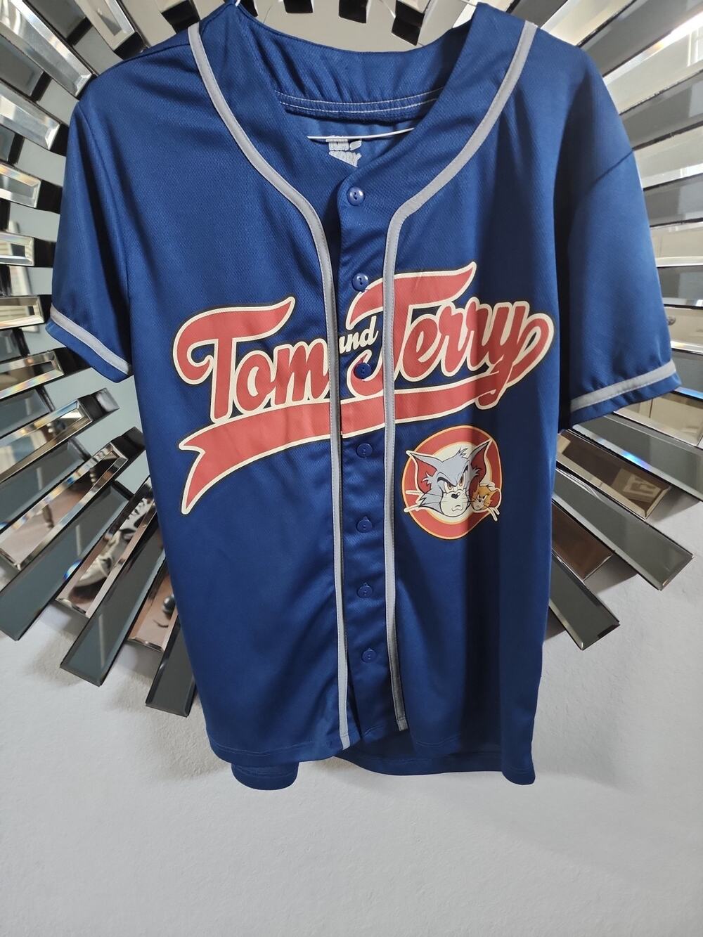 Tom and Jerry blue button up Jersey.\nSize mediumY